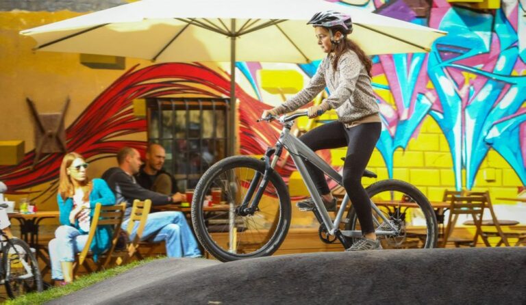 A girl riding a bike on a pump track